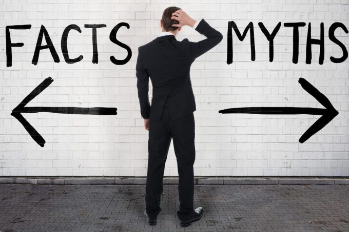 man looking At arrow signs below facts and myths